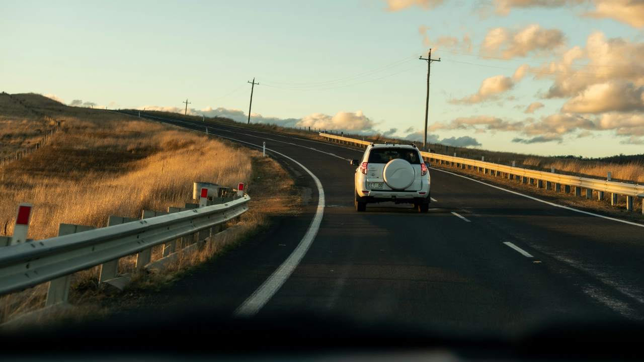 Car on Australian highway, smoothly driving.