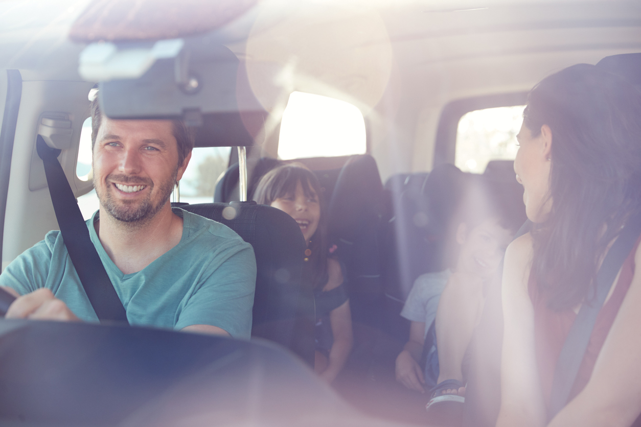 Family of four driving in their SUV.