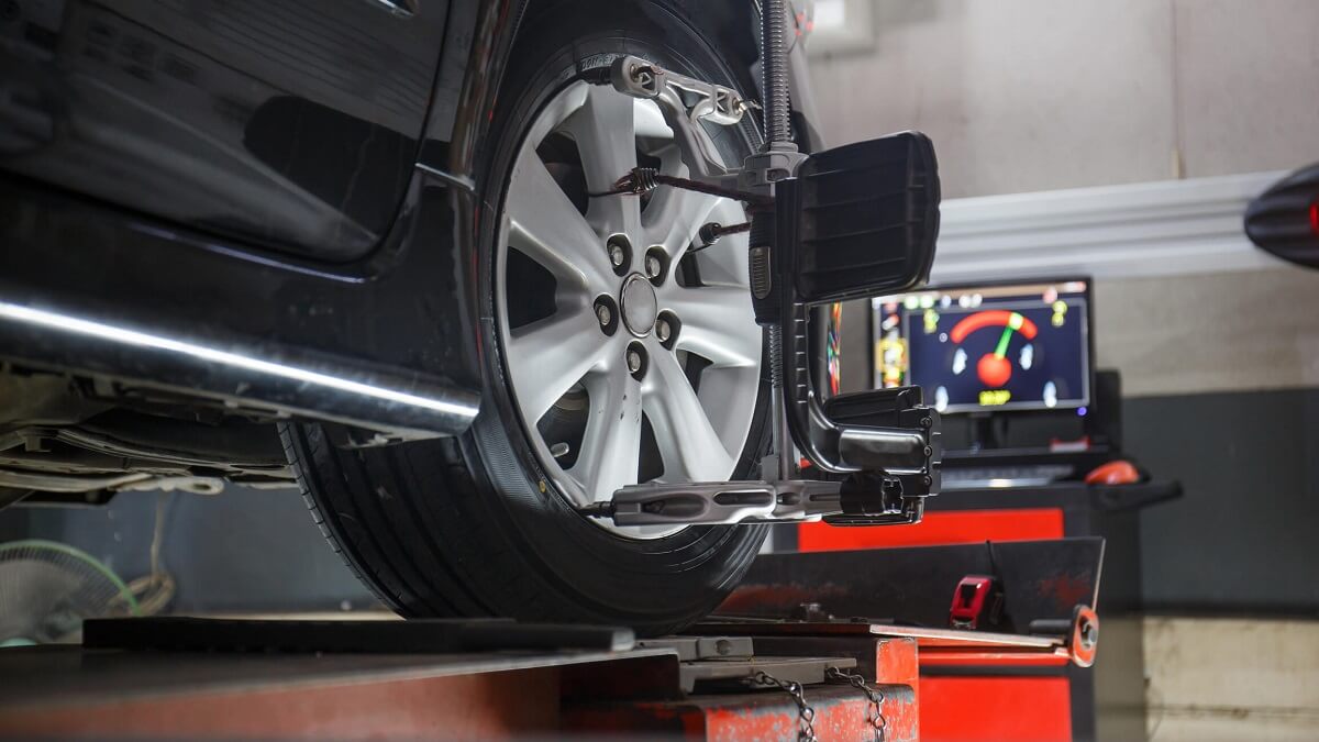 Vehicle in a workshop having a wheel alignment.