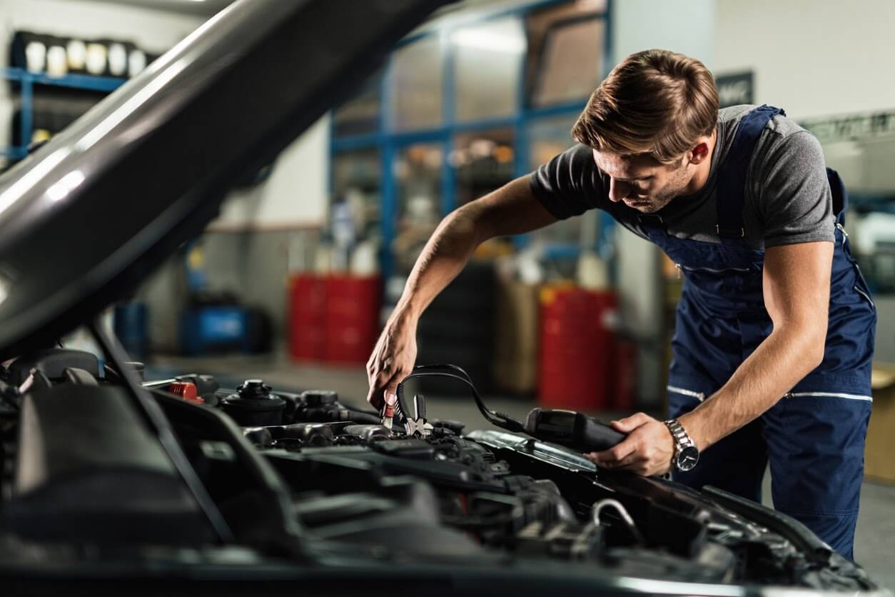 A qualified technician conducting a car service.