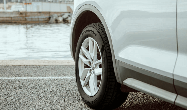 Close up image of a car's rear tyre and wheel.