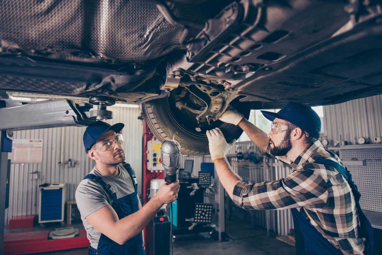 Regular alignment and rotation ensures that you get the most out of your tyres while also preventing uneven wear. Mechanics checking a wheel