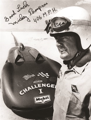 A signed black and white image of Mickey and the Challenger 1 land speed vehicle.