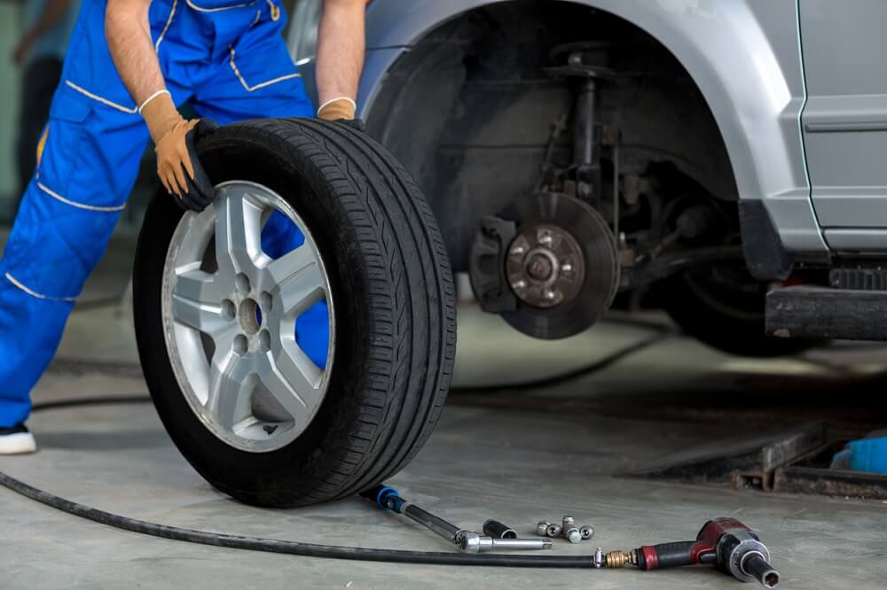 Mechanic with a tyre.