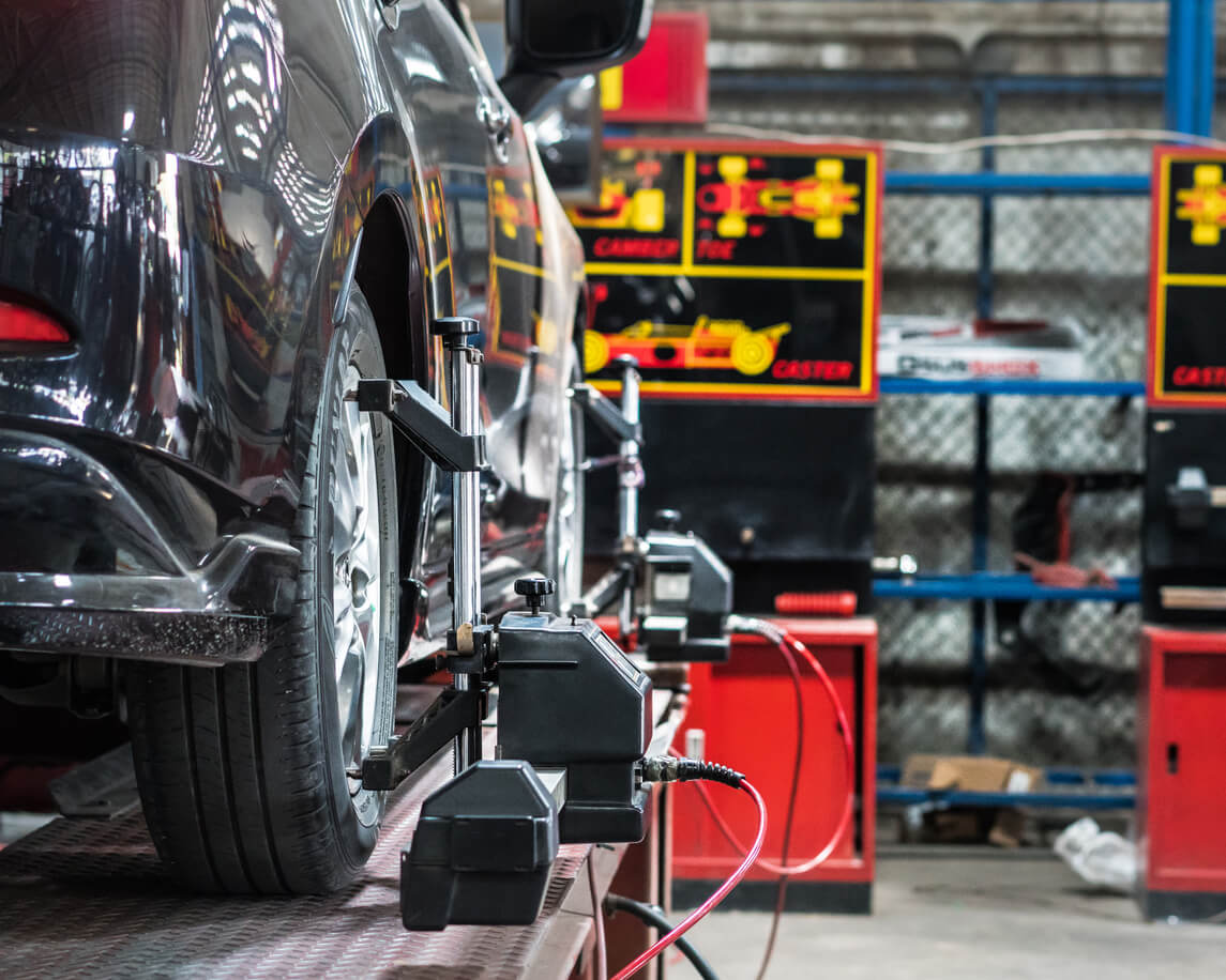 Alignment tools in progress at a local tyre shop.