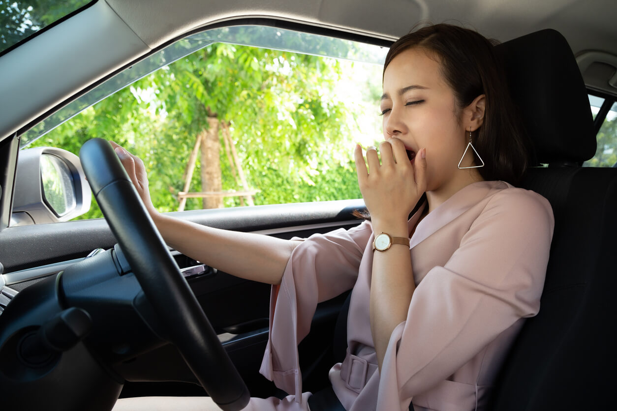Female driver yawning
